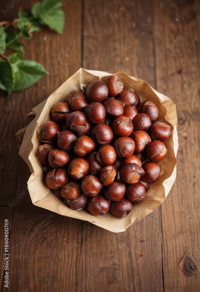 Obraz premium Aromatic chestnuts in a paper cone on a wooden table , wooden table, snack