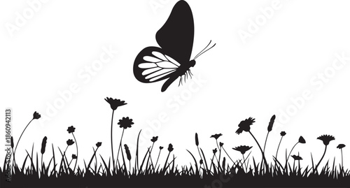 Black butterfly flying over wildflowers silhouette