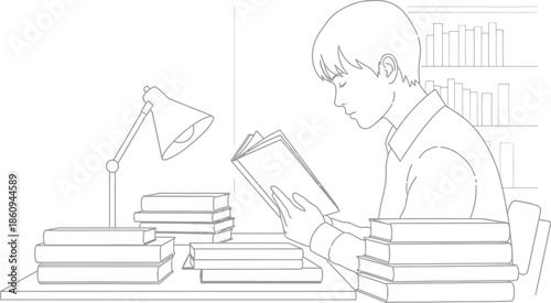 Young student diligently reading a book surrounded by many stacked textbooks while sitting at a desk with a desk lamp providing illumination