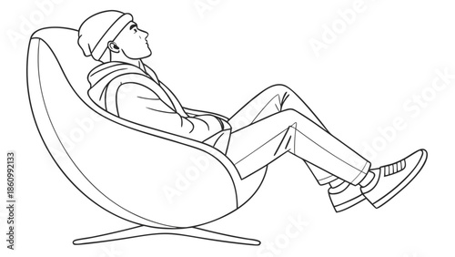 Young man relaxing in a modern chair, looking up thoughtfully