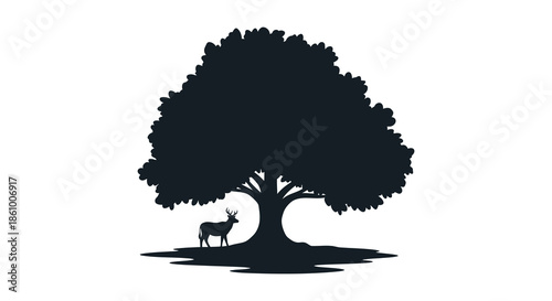A majestic oak tree provides a striking backdrop for a deer in a dark silhouette
