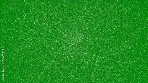 A green background with sparkling glitter particles in a video showcasing festive decorations . use as multipurpose tittle intro, gaming background. product mockup. motion graphics background
