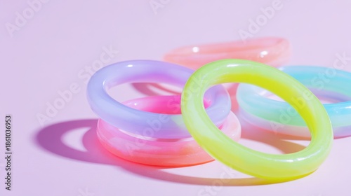Colorful Silicone Rings Stacked on a Pink Background