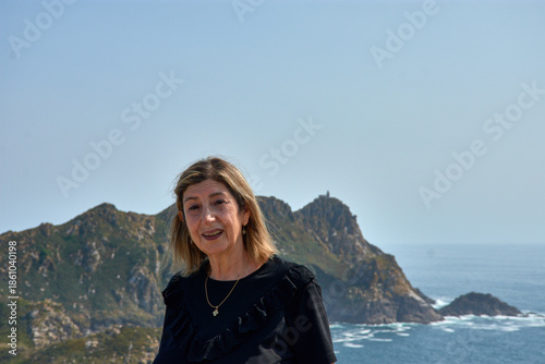Senior woman enjoying the breathtaking views of the Cies Islands landscape.