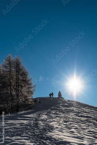 Silhouette of a man walking on the snow, Alps mountains