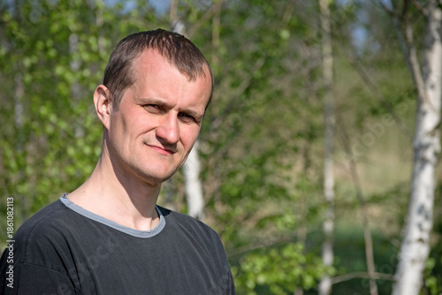 man portrait, European. the guy against the backdrop of nature. photo, smiling, thoughtful, surprised, indignant, feelings, emotions. fair skin, slight stubble. man 30-40 years old. close-up