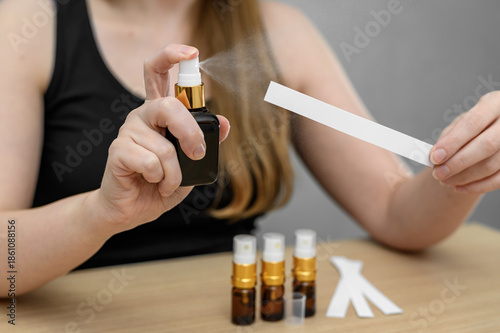 Photos A young girl uses perfume on a paper sampler, a blotter tester.