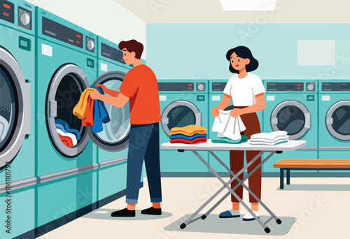 A man loads laundry into a machine while a woman folds clothes at a laundromat