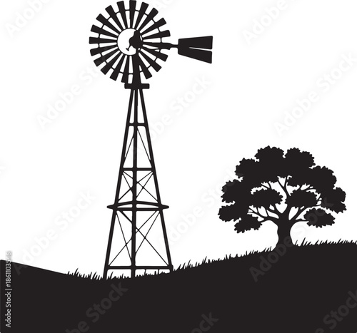 Black and White Silhouette of Old Farm Windmill and Tree on a Grassy Hill