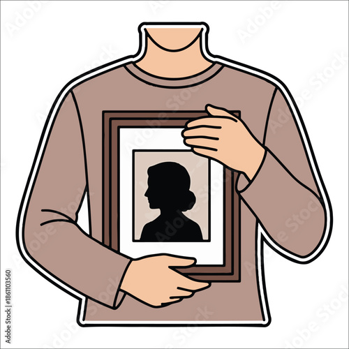 Title: A person wearing a pink shirt holding a framed of a silhouette black