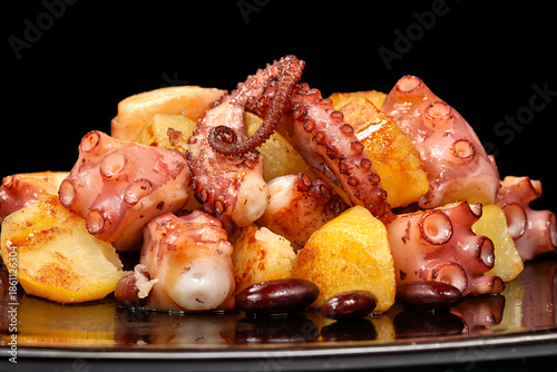 Galician dish Polbo a feira with octopus, potatoes, and spices served on a plate in a traditional setting