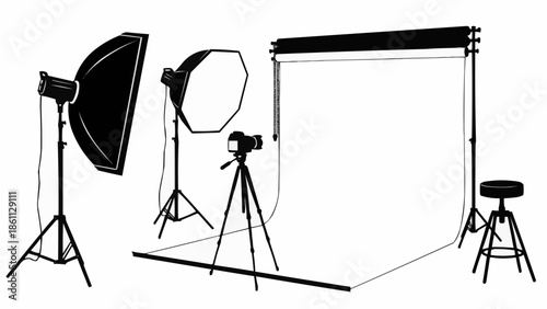 Photography studio setup with lighting equipment and camera on tripod.