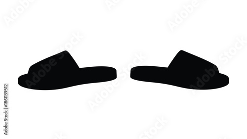 A pair of black slippers shown in a striking dark silhouette