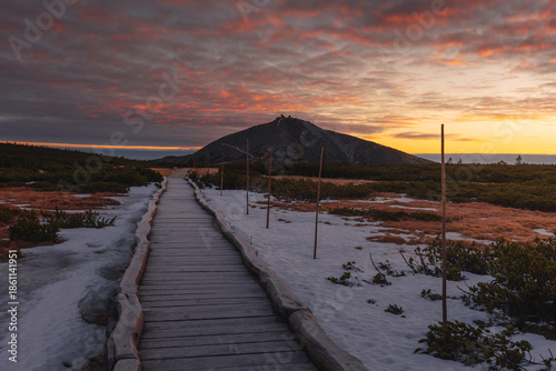 Autumn landscapes of the Karkonosze Mountains near Śnieżka, captured before winter. Dramatic sunrise and sunset light over ridges, valleys, and alpine scenery.