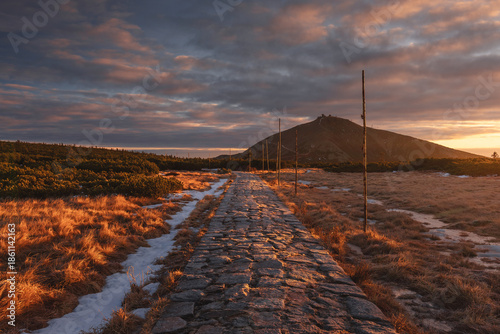 Autumn landscapes of the Karkonosze Mountains near Śnieżka, captured before winter. Dramatic sunrise and sunset light over ridges, valleys, and alpine scenery.