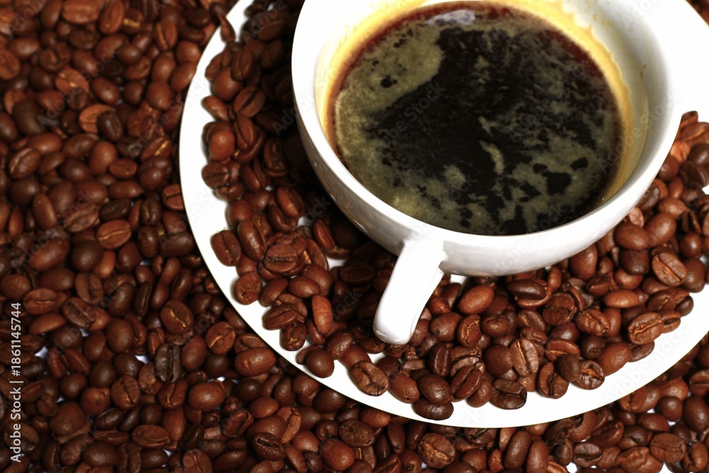 Fototapeta premium black coffee aroma coffee beans with black hot coffee in cup no people on a white background stock photo stock image