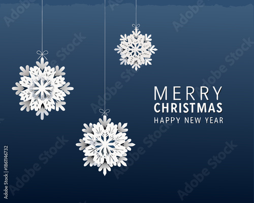Hanging paper snowflakes and a merry christmas greeting on a dark background