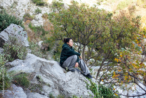 young pretty brunette girl hiking to waterfall, lifestyle people concept