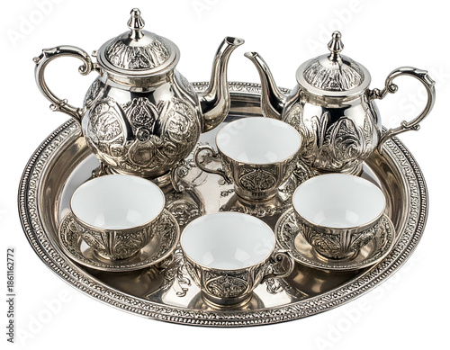 Silver tea set on tray; teapots, cups, saucers, intricate design