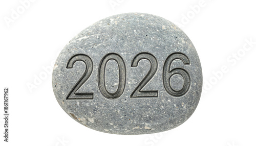 Year 2026 etched on a smooth, grey stone against a dark background