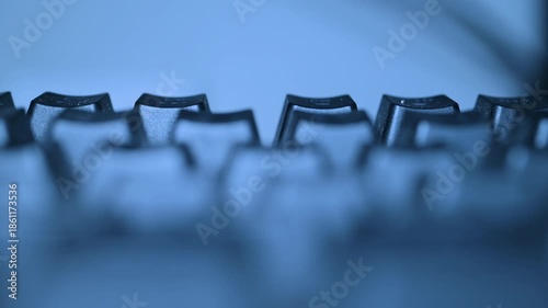 Abstract closeup of computer keyboard with blue lighting