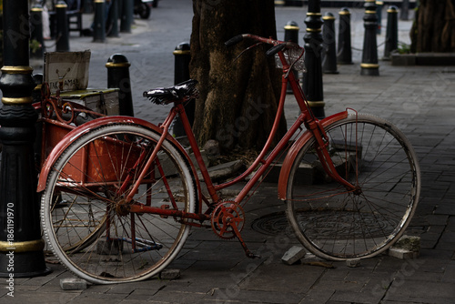 Vintage Red Bicycle Parked On Old Town Street