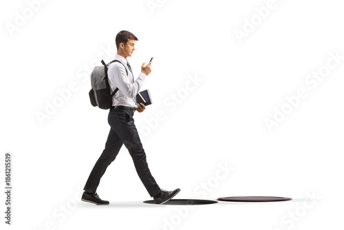 Bilde på lerret Full length profile shot of a distracted male student walking with a smartphone