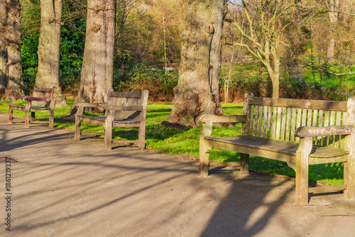 Empty wooden benches in Waterlow Park in Highgate, London, UK