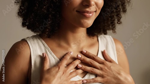 Woman with curly hair smiling with eyes closed