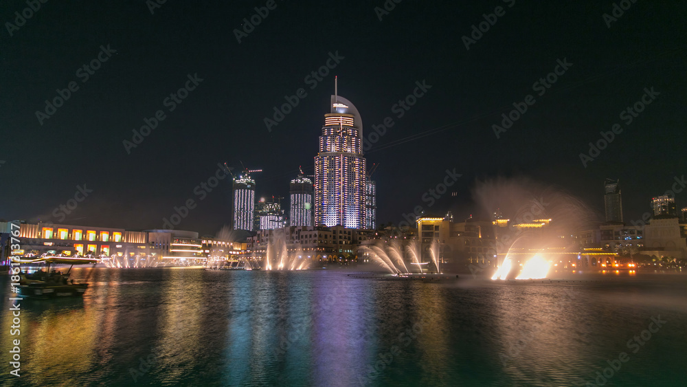 Obraz premium The Dancing Fountain of Dubai and lake day to night timelapse at dusk in Dubai, UAE.