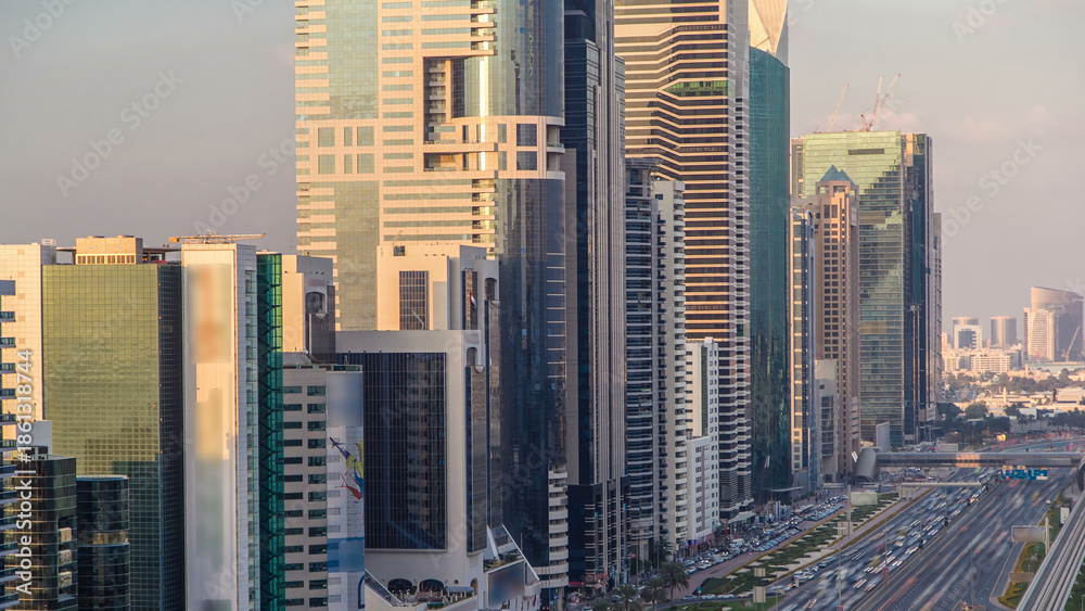 Obraz premium Downtown Dubai towers in the evening timelapse. Aerial view of Sheikh Zayed road with skyscrapers at sunset.