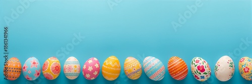Wallpaper Mural Colorful Easter eggs with painted patterns lined up on a vibrant blue background with copy space Torontodigital.ca
