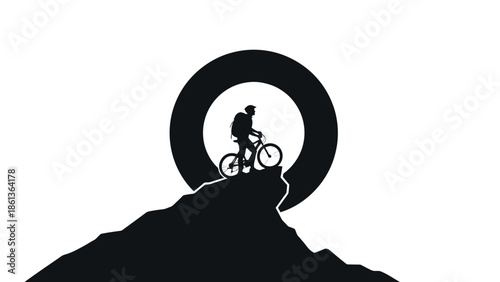 Silhouette of a cyclist on a mountain peak against a large circle.