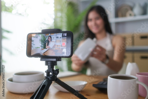 Female content creator recording video for online store.