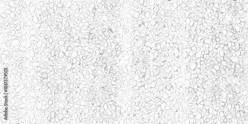 Close up view of a textured surface covered in small light colored pebbles