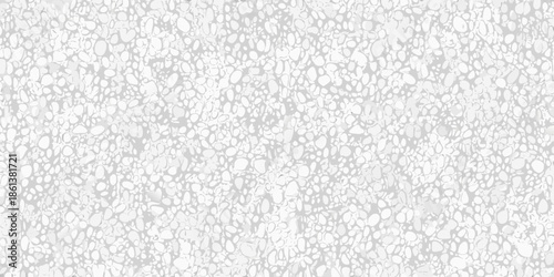 A grayscale texture featuring a dense arrangement of small irregular shapes