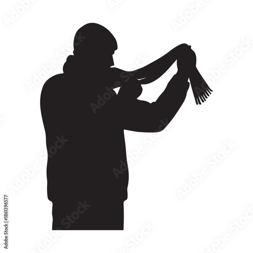 Silhouette of a person wearing a scarf for warmth in cold weather