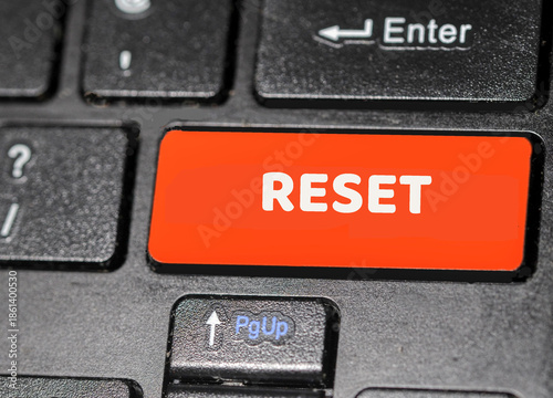 keyboard with red key and the word reset