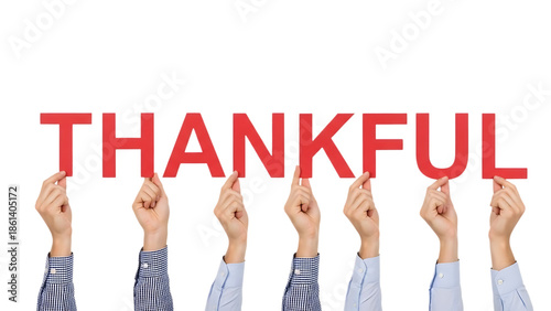 Hands Holding Up the Word thankful Against Black Background