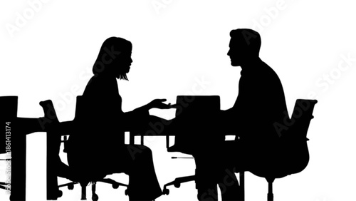 Two professional silhouettes of a man and woman engaging in a business discussion at a table