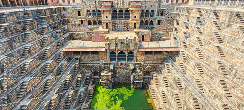 Chand Baori in Abhaneri, built in the 8th–9th century CE by King Chanda, is a deep, geometric stepwell with 3,500 steps, showcasing ancient water conservation, climate-smart design.