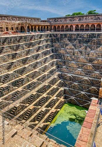 Chand Baori in Abhaneri, built in the 8th–9th century CE by King Chanda, is a deep, geometric stepwell with 3,500 steps, showcasing ancient water conservation, climate-smart design.