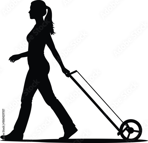Silhouette of woman walking with luggage cart