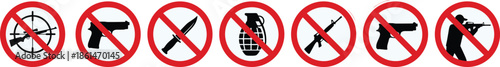 A set of red no-entry signs featuring symbols of various weapons, including guns, grenades, and knives, emphasizing weapon prohibition.
