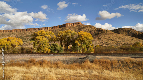Rail Line Through a Desert Valley with Fading Seasonal Foliage