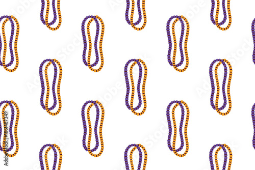 Mardi Gras. Continuous texture of traditional tricolor plastic beads necklaces. Iconic carnival accessory background for Fat Tuesday party costumes festive fabrics and holiday gift wrap