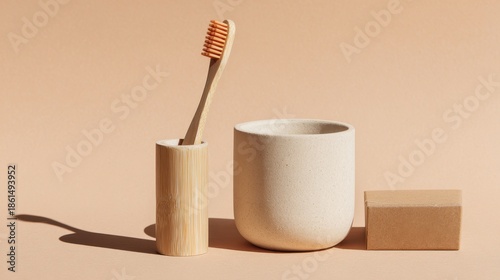 Sustainable bathroom set with bamboo toothbrush ceramic cup and natural soap bar on beige background