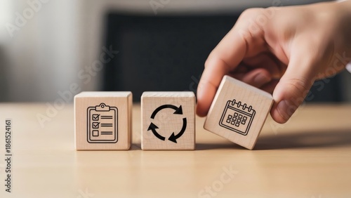 Annual Business Planning Strategy. Wooden blocks with checklist cycle and calendar icons, symbolizing review adjustment flexibility and continuous business improvement.
