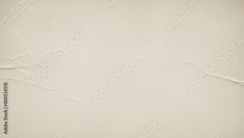 A closeup view of a beige colored paper background with wrinkles and creases