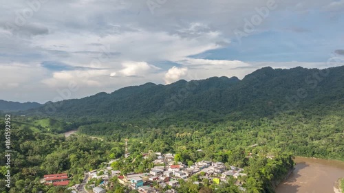 Aerial hyperlapse over Tapijulapa, Pueblo Mágico in Tabasco, Mexico, revealing lush green mountains, dense vegetation, and the river carving through the tropical landscape.